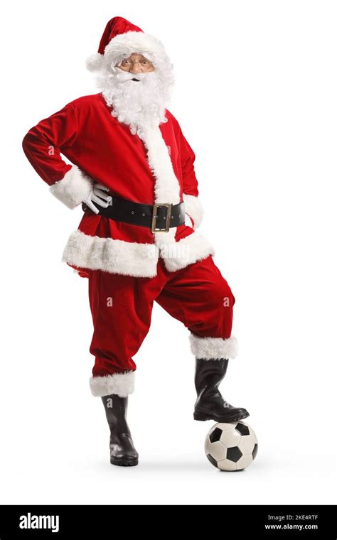 Full Length Portrait Of Santa Claus Standing With A Football Isolated