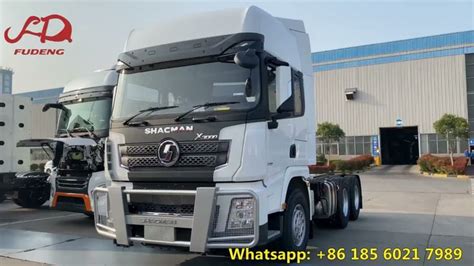 Two Trucks Are Parked In Front Of A Building