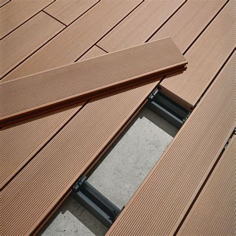 An Open Door On The Side Of A Wooden Deck With Metal Bars In Between It