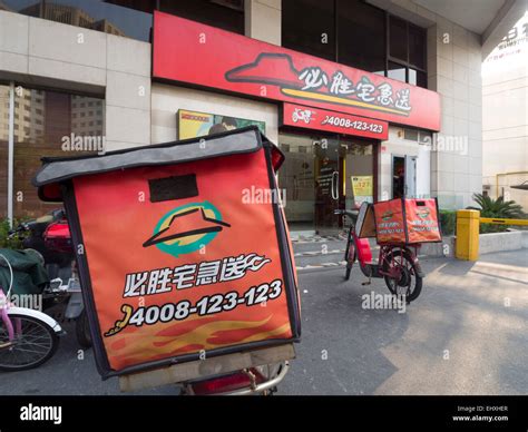 Delivery motorcycle outside a Pizza Hut restaurant in Shanghai, China ...