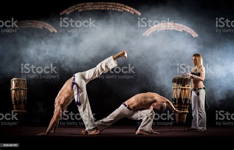 Capoeira Dancers Fighting On A Sports Training With Music Background