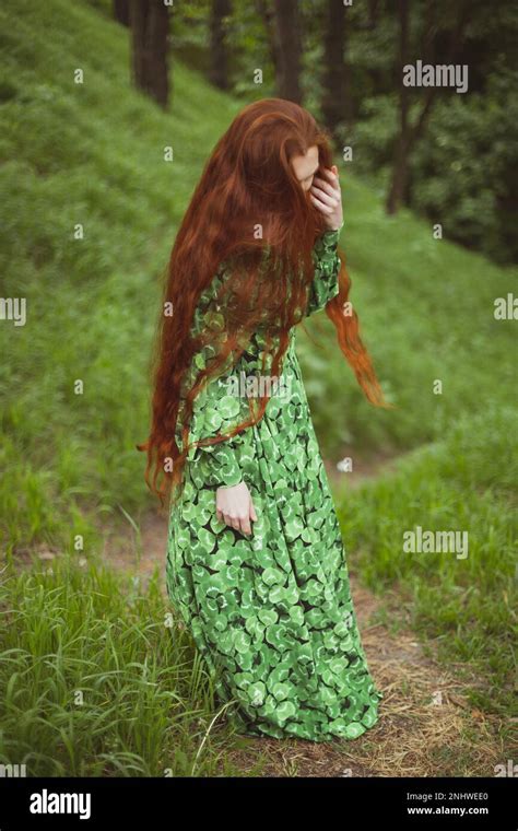 Close Up Ginger Haired Woman In Long Dress Standing On Pathway Portrait