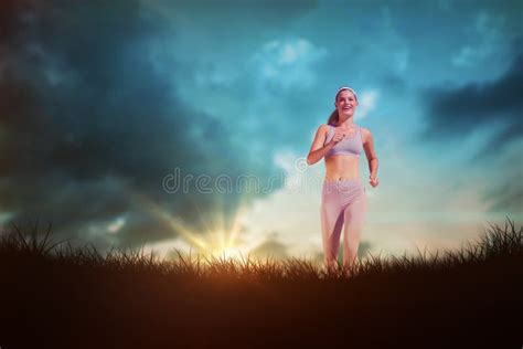Composite Image Of Sporty Blonde Jogging Towards Camera Stock Photo