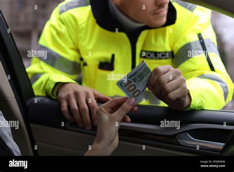 Woman Giving Bribe To Police Officer Out Of Car Window Closeup Stock