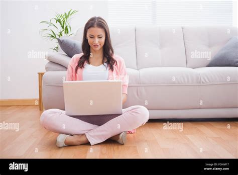 Pretty Brunette Using Her Laptop Sitting On Floor Stock Photo Alamy
