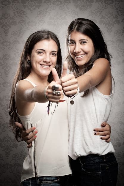 Premium Photo Two Happy Girls With Thumbs Up