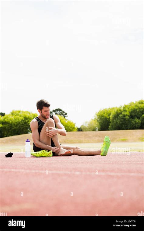 Tired Athlete Sitting On The Running Track Stock Photo Alamy