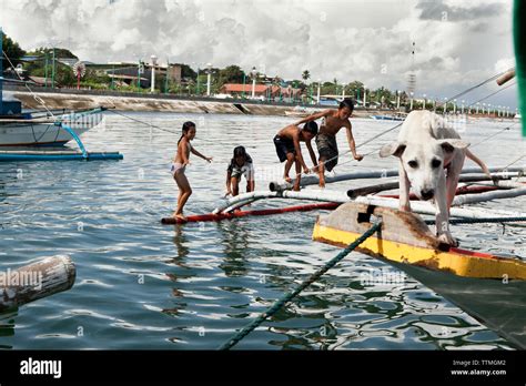 PHILIPPINES, Palawan, Puerto Princesa, kids play on fishing boats in ...