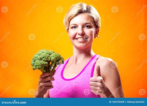 A Portrait Of Smiling Woman Holding Broccoli People Healthcare And