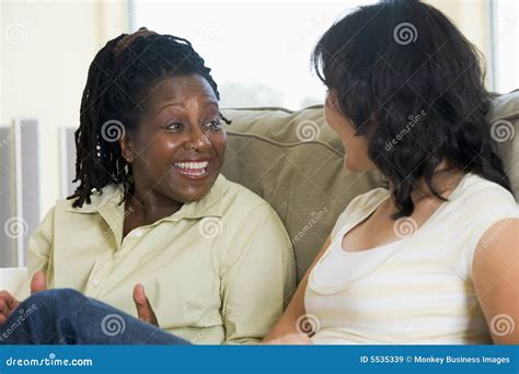 Two Women Talking In Living Room And Smiling Stock Image Image Of