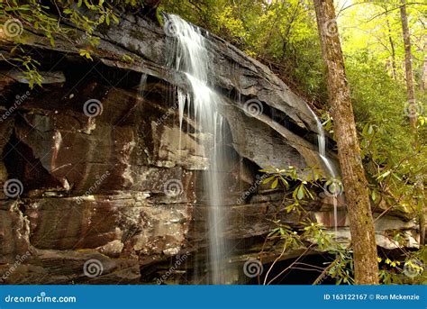 Silky Smooth Water Fall Flowing Down The Rocky Terrain Stock Image