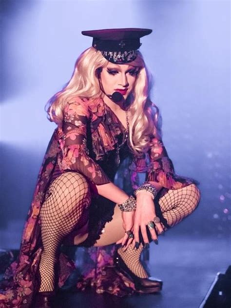 Lady In Fishnet Tights And Hat On Stage With Legs Spread Out To The Side