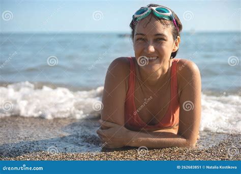 Portrait Laughing Tanned Woman In Goggles Bikini Pebble Beach Wave