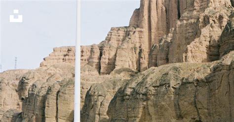 White and black satellite on top of brown rock formation during daytime ...