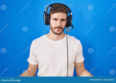 Hispanic Man With Beard Listening To Music Wearing Headphones Clueless