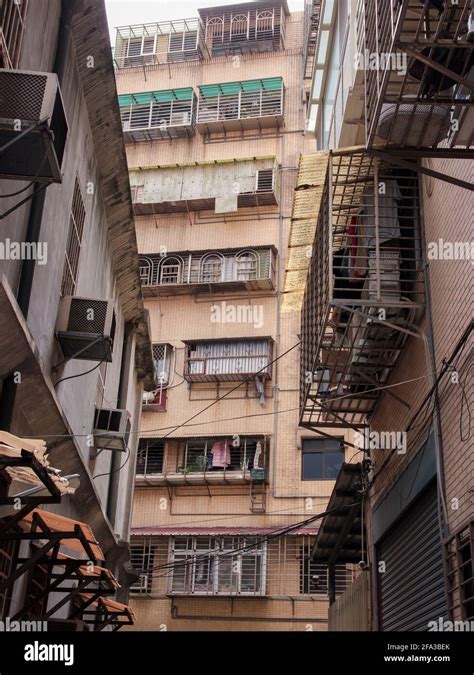 Looking up at some old apartment buildings with balcony bars in a local ...