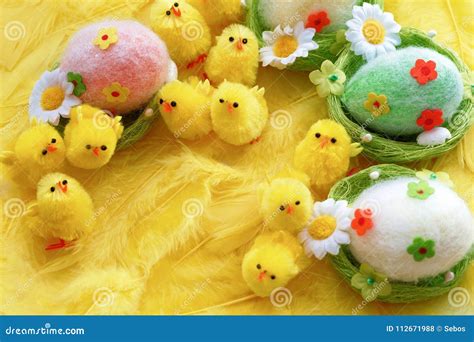 Baby Yellow Easter Toys Chicks and Eggs on a Background of Feathers ...