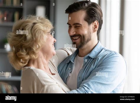 Close Up Smiling Mature Mother And Adult Son Hugging Stock Photo Alamy