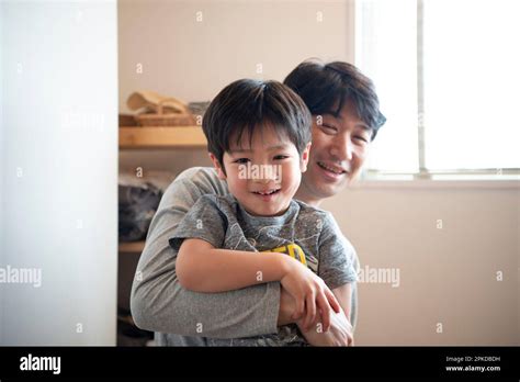 Parent And Child Laughing At Home Stock Photo Alamy