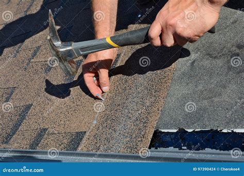 Worker Hands Installing Bitumen Roof Shingles Worker Hammer In Nails