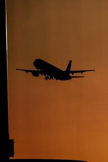 Premium Photo Silhouette Airplane Flying In Orange Sky