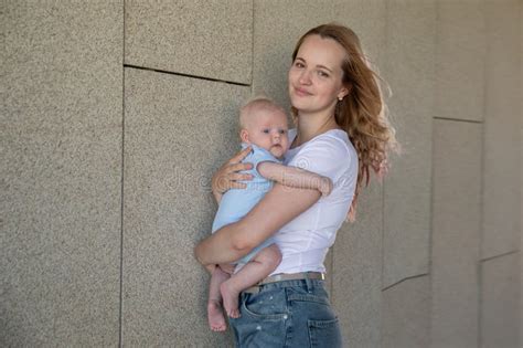 A Young Mother Walks With Her Son Around The City Stock Image Image