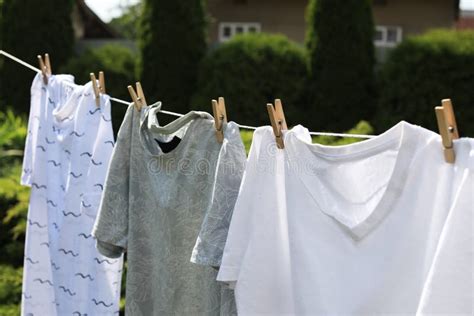 Washing Line With Clean Clothes In Garden Drying Laundry Outside Stock