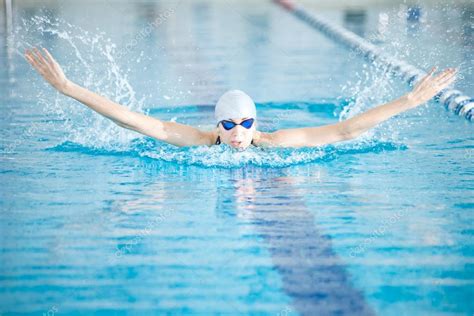 Girl Swimming In Butterfly Stroke Style Stock Photo By ©markin 52924337