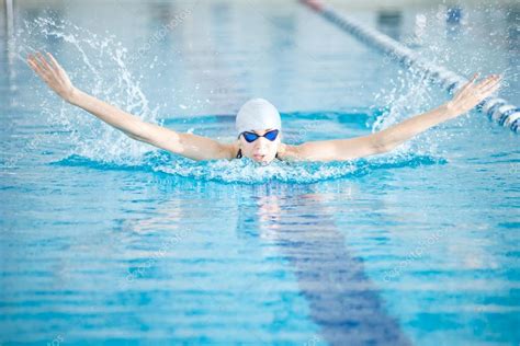 Girl swimming in butterfly stroke style Stock Photo by ©markin 52924337