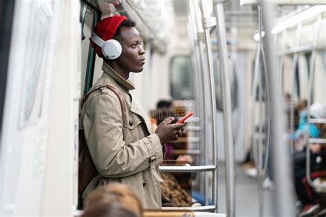 Afro American Passenger Man In Red Hat Trench Coat Stand In Subway