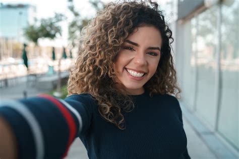 Premium Photo Young Woman Taking Selfies While Standing Outdoors On