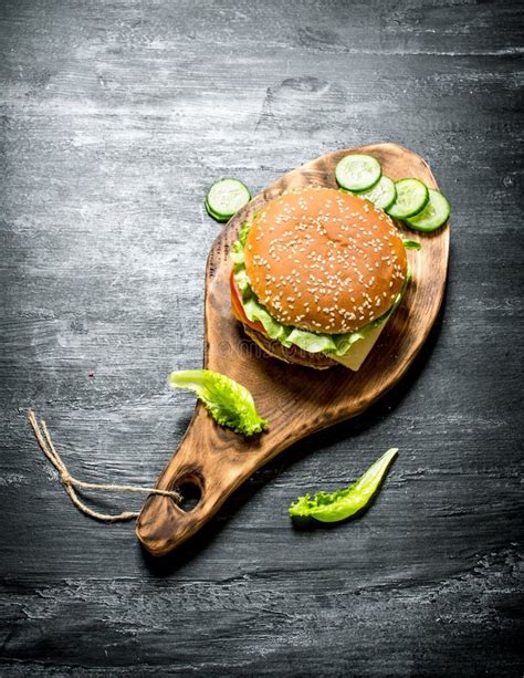 Burger On A Cutting Board With Cucumber And Herbs Stock Image Image