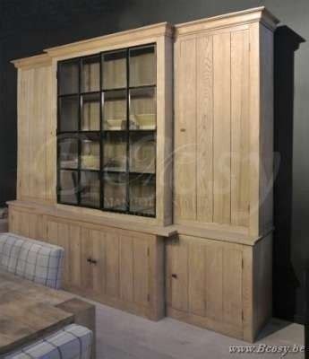 A Large Wooden Cabinet With Glass Doors In The Middle Of A Dining Room