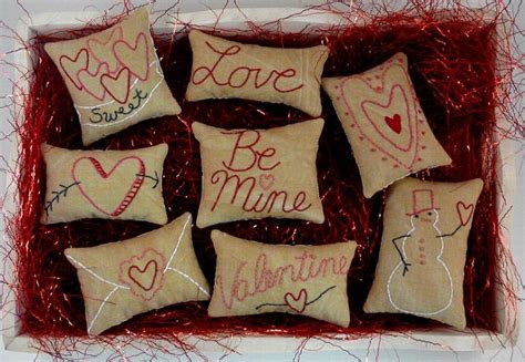 Six Embroidered Pillows In A Gift Box With Red String On The Bottom And