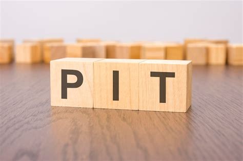 Premium Photo The Wooden Blocks Forming The Word Pit Personal Income