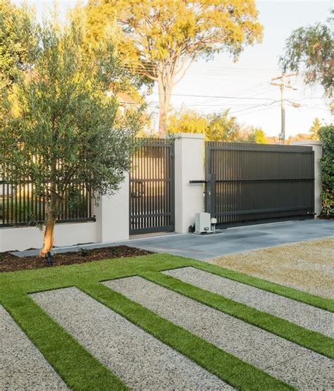 A Modern House With Grass And Trees In The Front Yard