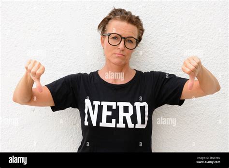 Mature Nerd Woman Wearing Big Eyeglasses And Standing Against White