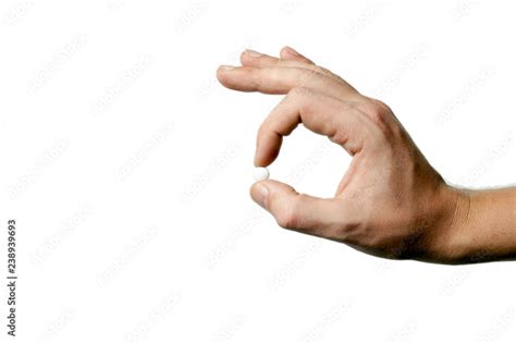 Man S Hand Holding A White Pill Between Thumb And Forefinger Isolated