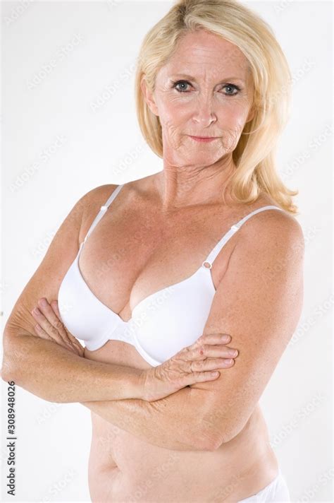 Portrait Of Semi Nude Mature Woman With Arms Crossed Stock Photo