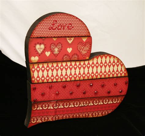 Two Red Heart Shaped Boxes Sitting On Top Of Each Other