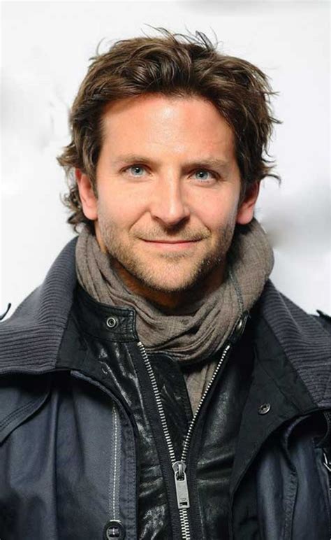 A Close Up Of A Person Wearing A Black Jacket And Scarf With A Smile On