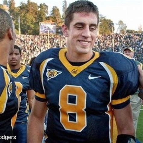 two football players standing next to each other in front of a large ...