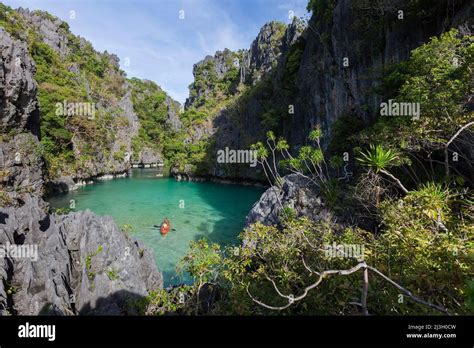 Philippines Palawan El Nido Bacuit Archipelago Isolated Tourists Paddling In A Sea Kayak On