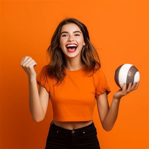 Premium AI Image Photo Of Excited Sports Fan Girl Holding A Ball