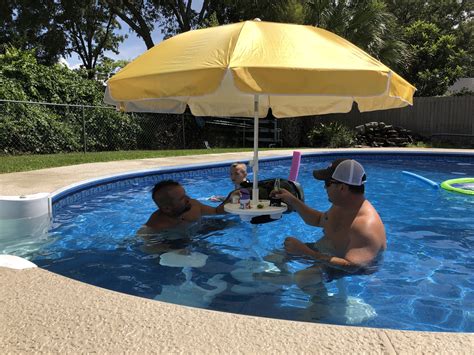 This umbrella table for your pool doubles as a shady bar to sit down ...