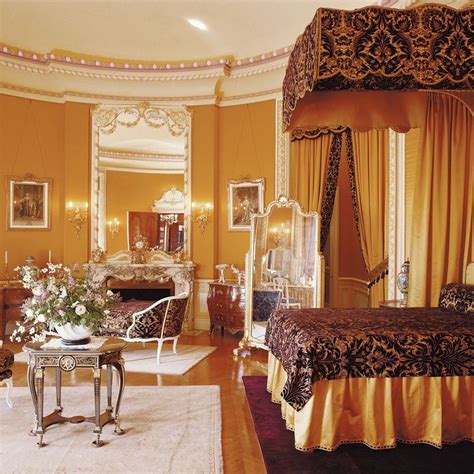 an ornate bedroom with yellow walls and furniture