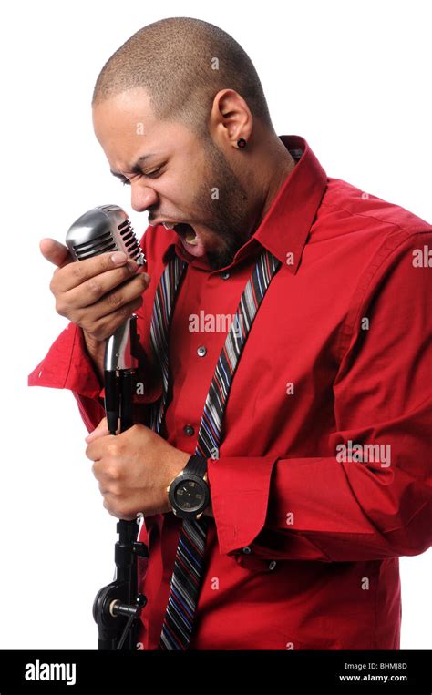 Young African American Man Singing Into Vintage Microphone Stock Photo