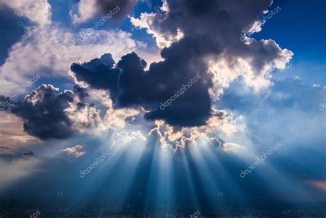 Rays of light shining through dark clouds — Stock Photo © Deerphoto ...