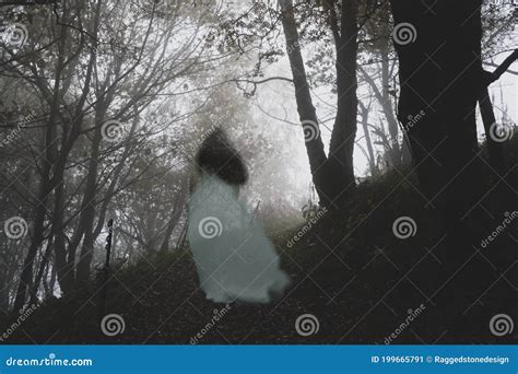 A Spooky Ghostly Woman In A Long White Dress Walking Up A Path Through