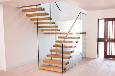 Floating Staircase With Thick Treads And A Glass Balustrade Modern